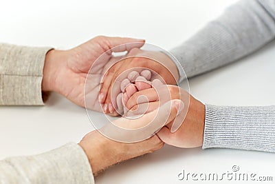 Close up of old man and young woman holding hands Stock Photo