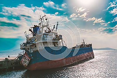 Close up an old shipwreck boat abandoned stand on beach or Shipwrecked off the coast of Stock Photo