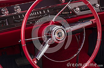 Old vintage car steering wheel and cockpit. Retro styled image of an old car radio inside classic car Chevrolet Editorial Stock Photo