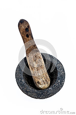 Close up of old vintage mortor and pestle isolated on white till date used in Asian and Indian homes for grinding and crushing spi Stock Photo