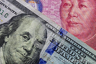 Close up of one hundred Dollar banknote over a 100 Yuan banknote with focus on portraits of Benjamin Franklin and Mao Tse-tung/USA Stock Photo