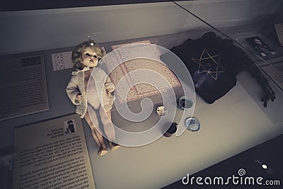 Close up of one of Yad Vashem expositions showing the old doll and the text about it's owner Eva Modval, who was deported to Editorial Stock Photo