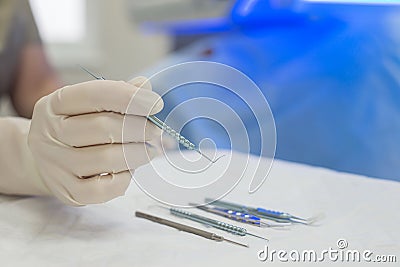 Close-up of an ophthalmologist doctor holding instruments for microscopic eye surgery in his hand over a sterile table Stock Photo