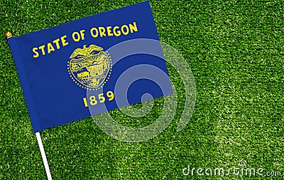 Close-up of Oregon flag against closed up view of grass Stock Photo