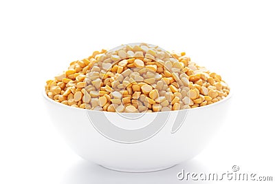 Close-up of Organic Bengal Gram Cicer arietinum or split yellow chana dal inside a ceramic white bowl Stock Photo