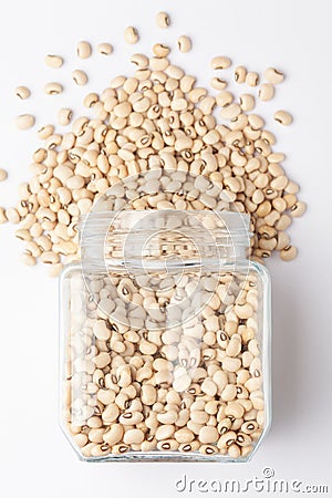 Close up of Organic soybean, Glycine max or soya bean dal spilled and in a glass jar. Stock Photo