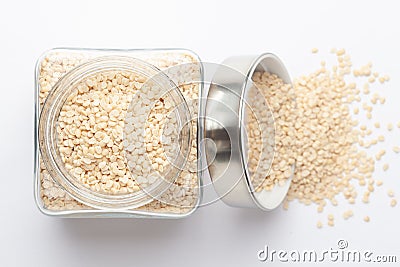 Close up of Organic split polished white urad dal Vigna mungo in a glass jar with Lid. Stock Photo