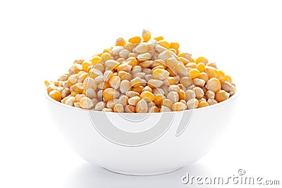 Close up organic yellow corn seed or maize Zea mays inside a white ceramic bowl Stock Photo