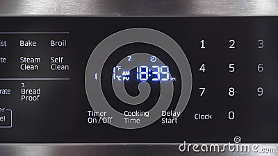 Close up of oven display flickering, control panel blinking. Electricity problem Stock Photo
