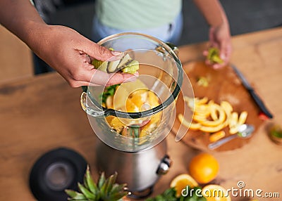 Close up overhead shot of hands preparing smoothie in glass blender kiwi Stock Photo