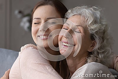 Happy elderly mother and senior daughter hug and cuddle Stock Photo