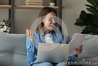 Close up overjoyed woman reading good news in paper letter Stock Photo