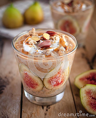 Close-up of oats and chia seeds pudding with figs, on wooden background Stock Photo