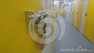 A close up of a padlock and the end of a storage unit corridor Editorial Stock Photo