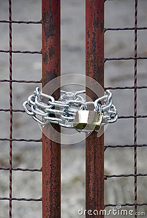 Close up of a padlock, gate and chain Stock Photo