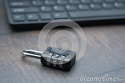 Close up of padlock and keyboard on table Stock Photo