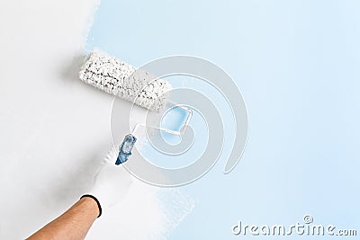 Close up of painter hand painting a wall Stock Photo