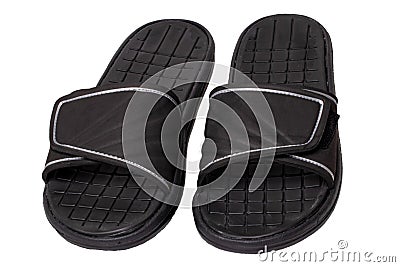 Close-up of a pair of black rubber sandals or slippers for the shower swimming pool or beach with slip-resistant outsole Isolated Stock Photo