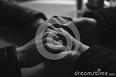 Close-up pair of holding hands lovers Stock Photo