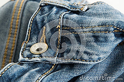 Close-up of a pair of jeans with the word Stock Photo