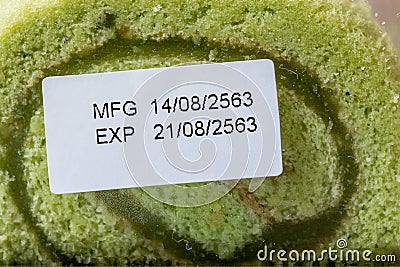 Close up pandan flavor roll cake in package with expiry date tag Stock Photo