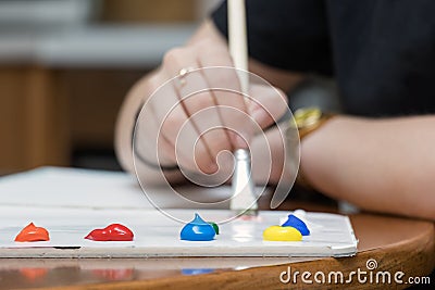 Close-up of paper painter color palette with acrylic paint on a table Stock Photo