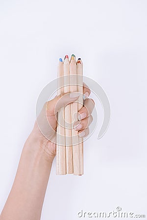 Close-up partial view of human hand holding crayons Stock Photo