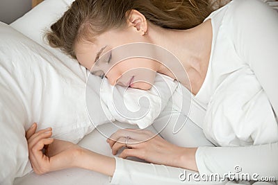 Close up peaceful calm young woman sleeping in comfortable bed Stock Photo