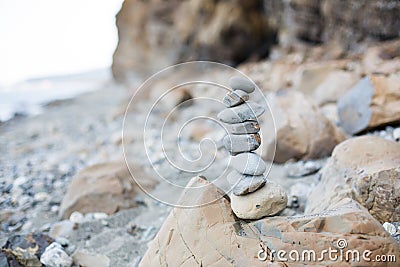 Close-up of pebble wishing Pyramid at the seaside. Image of stone tower on the beach Stock Photo