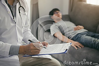 Close up of pen doctor writing with came to visit the patient at home while he was suffering from stomach ulcers and noted the tre Stock Photo