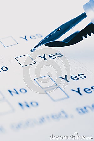 Close up of a pen ready to fill yes or no check boxes Stock Photo