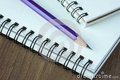 Close up pencil and spiral notebook on wood table Stock Photo