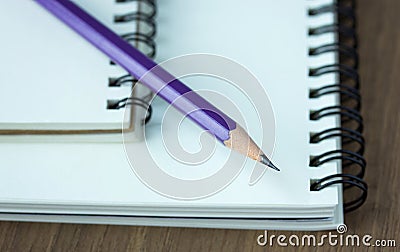 Close up pencil and spiral notebook on wood table Stock Photo