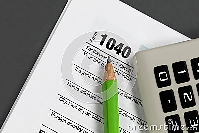 Close up of pencil tip with small calculator and standard tax form Editorial Stock Photo