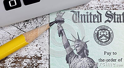 Close up of pencil tip with tax refund check and calculator in background Editorial Stock Photo