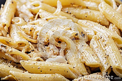 Close up Penne Rigate noodles and Carbon Pasta Sauce Stock Photo