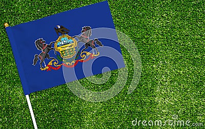 Close-up of Pennsylvania flag against closed up view of grass Stock Photo