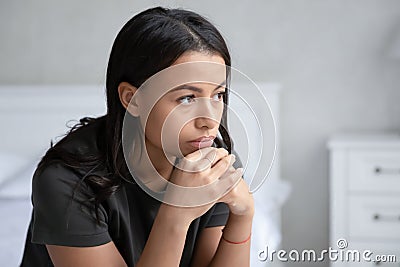 Pensive biracial woman look in distance thinking Stock Photo
