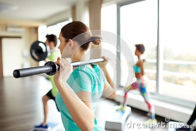 Close up of people exercising with bars in gym Stock Photo