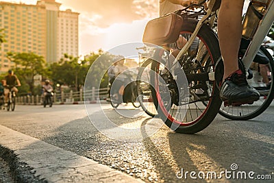 Close-up people riding on bike in the city street at early morning. Outdoor excercise sport Stock Photo