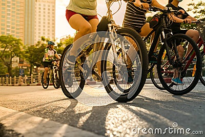 Close-up people riding on bike in the city street at early morning. Outdoor excercise sport Editorial Stock Photo