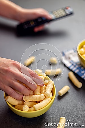 Close up of person with corn puffs, pufuleti or corn crisps Stock Photo