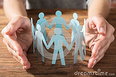 Person Protecting Paper Cut Out Figure Stock Photo