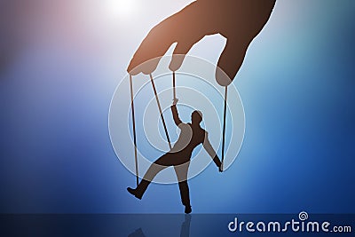 Person`s Hand Controlling Puppet Man Stock Photo