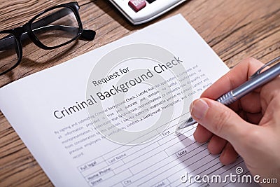 Person Filling Criminal Background Check Form Stock Photo