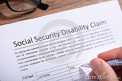 Person Filling Social Security Disability Claim Form Stock Photo