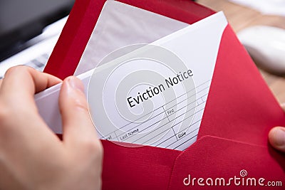 Person Holding Eviction Notice In Envelope Stock Photo