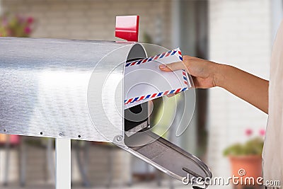 Person Removing Letter From Mailbox Stock Photo