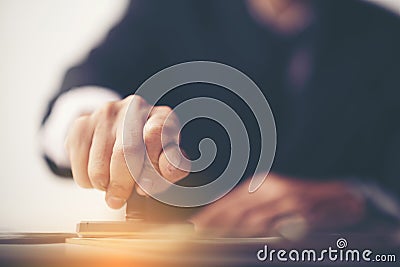 Close-up Of A Person's Hand Stamping With Approved Stamp On Docu Stock Photo