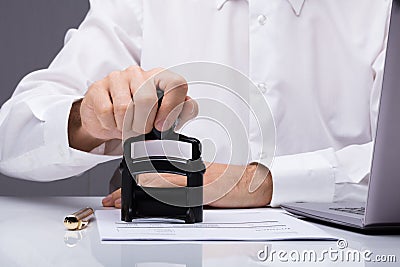 Person`s Hand Stamping With Approved Stamp Stock Photo